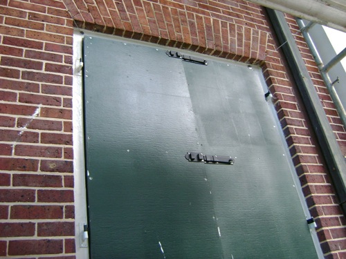 new reproduction shutters, showing impact-resistant fiberglass panel.