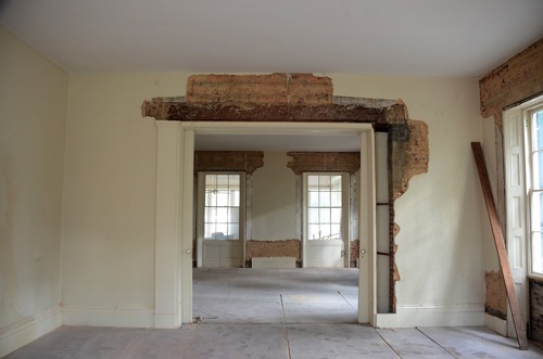 View from the parlor to the dining room with pocket door pediment removed, revealing the heart pine transom that spans the opening.