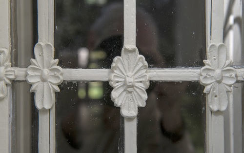 cast-lead ornaments installed and re-painted on the entry door sidelights.